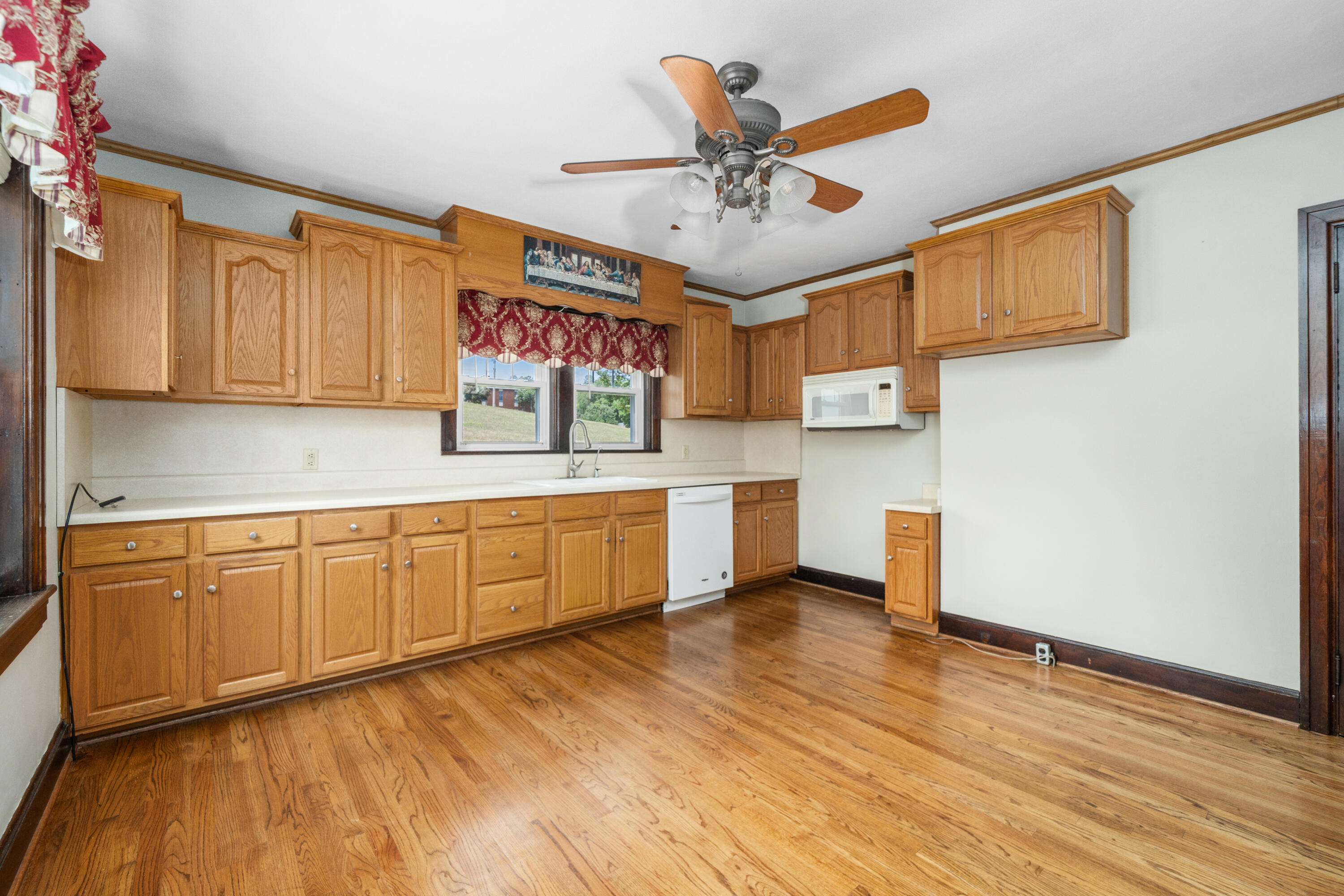 77 Mountain Pass Road Blue Ridge, VA 24064 - Photo 5 of 25 a kitchen with stainless steel appliances granite countertop a sink cabinets and wooden floor