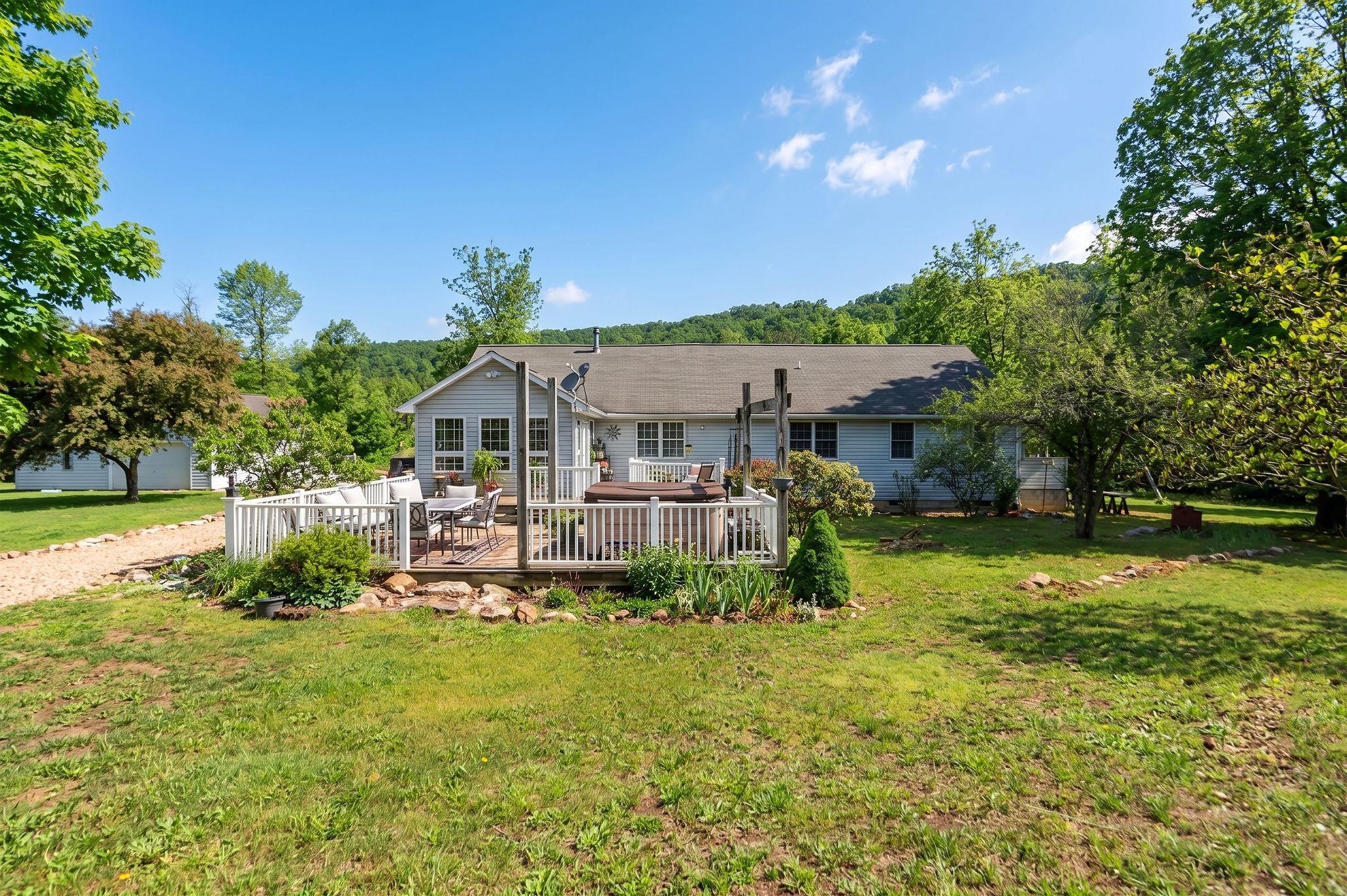 516 Estaline Valley Road Craigsville, VA 24430 - Photo 64 of 75 a view of a house with a yard patio and fire pit