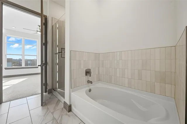 a bathroom with a bathtub and shower