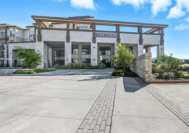 a view of a building with potted plants