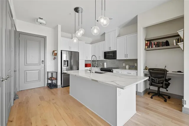 a view of a kitchen and microwave