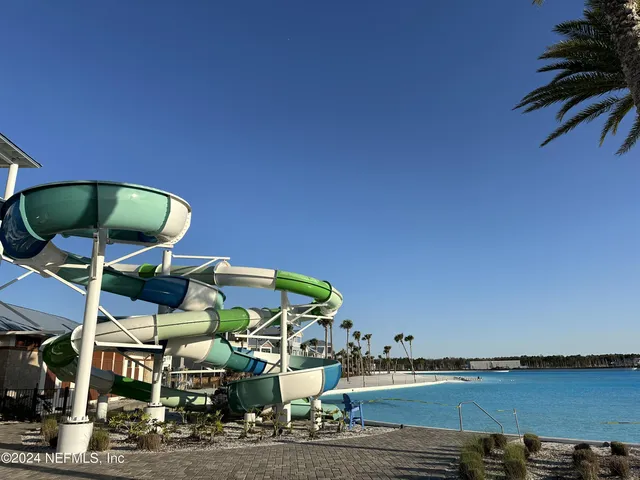 a view of a chairs and table in front of a lake