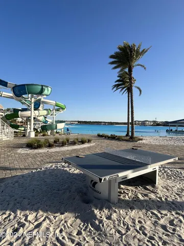 a view of a swimming pool with a table and chairs
