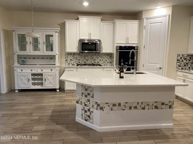 a bathroom with a sink a mirror and bathtub