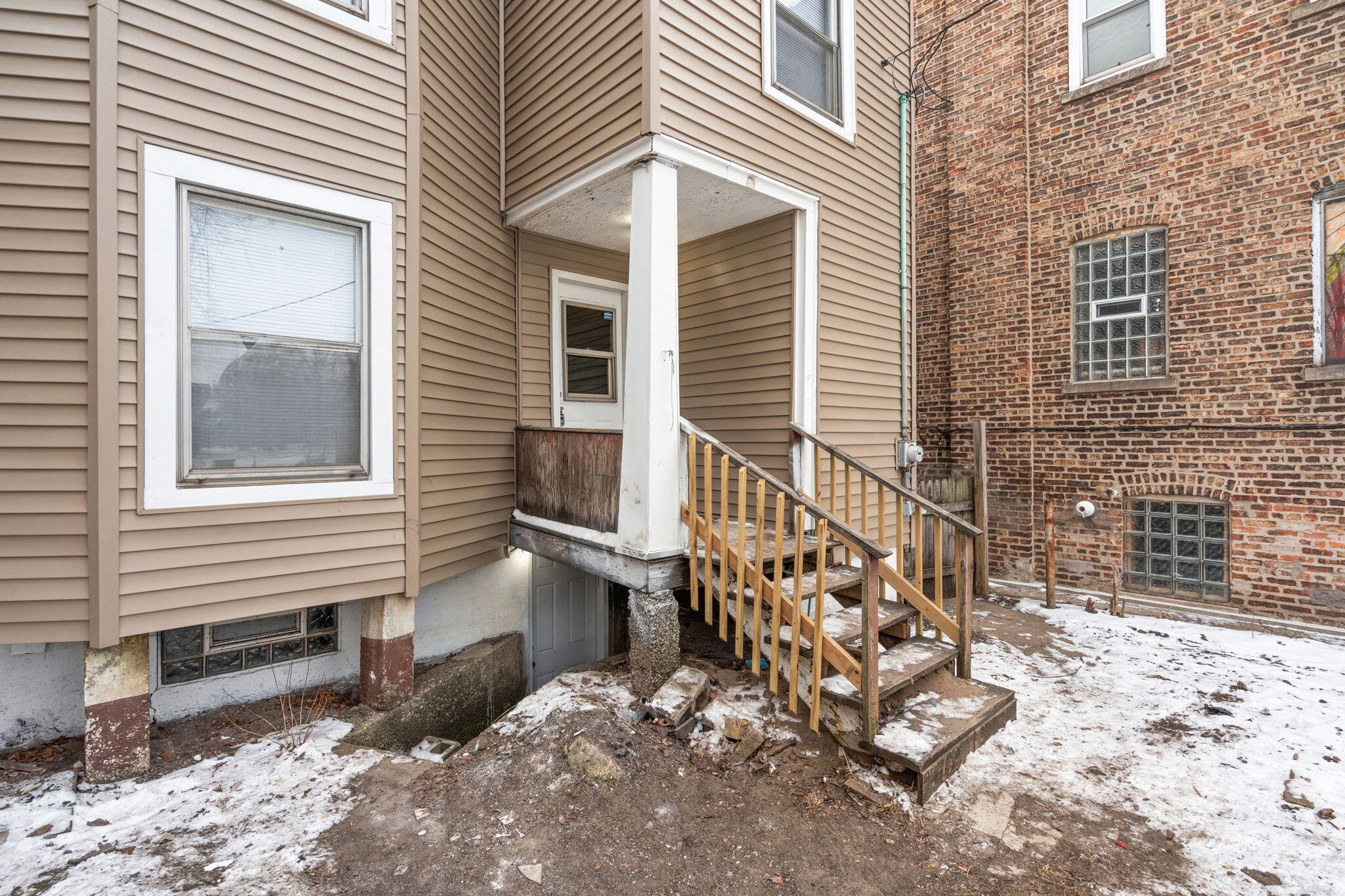 565 Jackson Street Gary, IN 46402 - Photo 24 of 24 a view of a house with a yard and wooden bench
