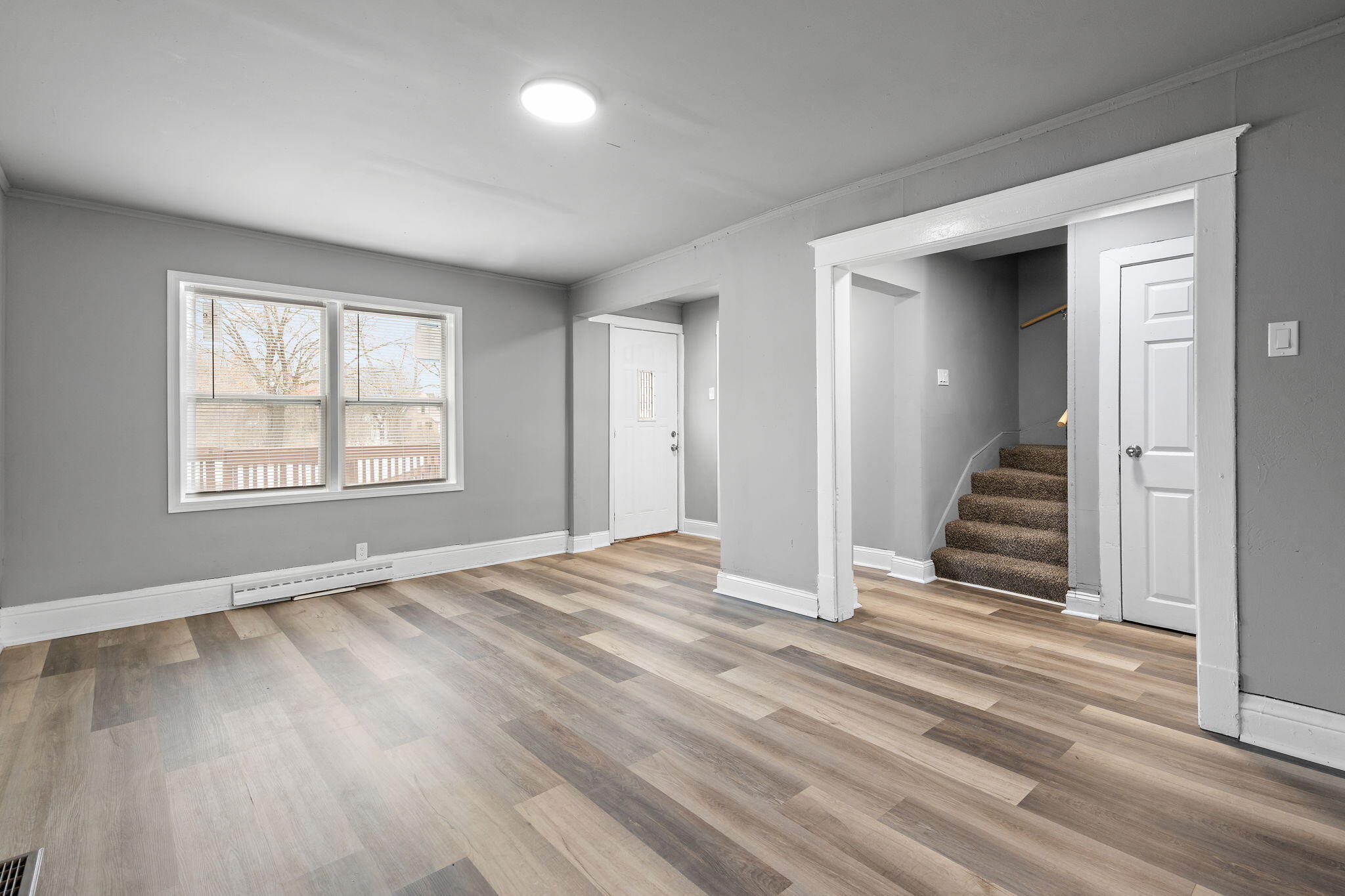 565 Jackson Street Gary, IN 46402 - Photo 7 of 24 an empty room with wooden floor and a window