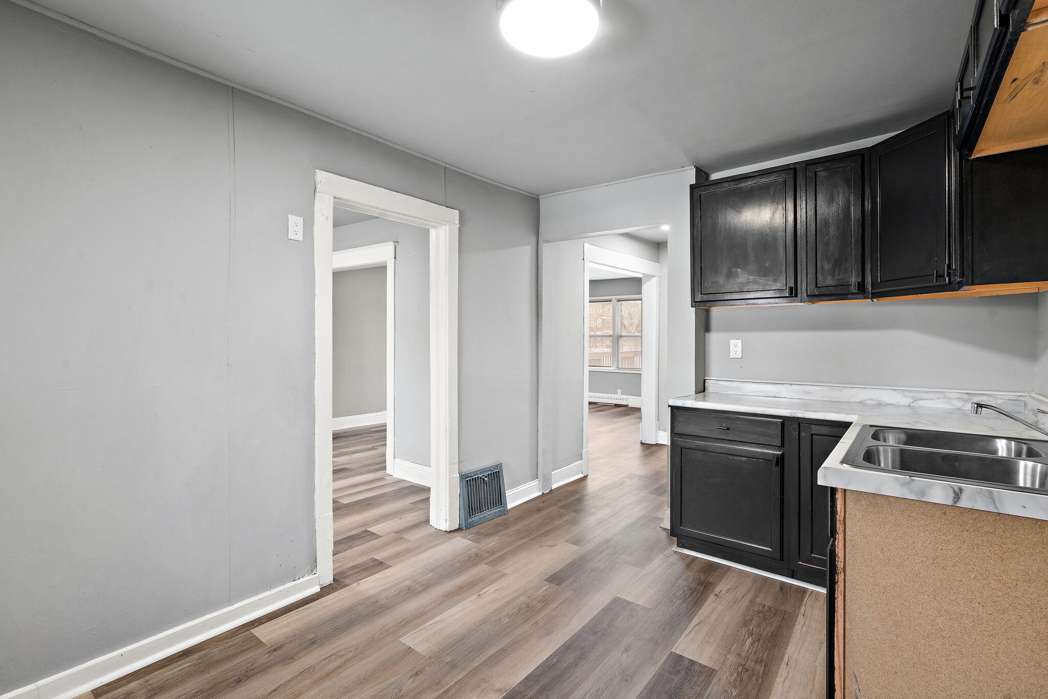 565 Jackson Street Gary, IN 46402 - Photo 8 of 24 a kitchen with granite countertop wood cabinets and stainless steel appliances