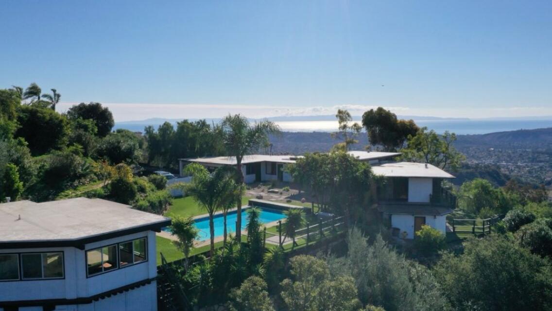 an aerial view of a house with yard table and chairs