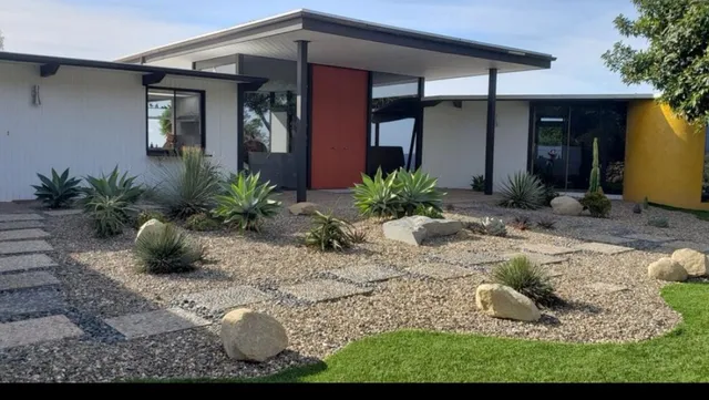 a front view of a house with garden