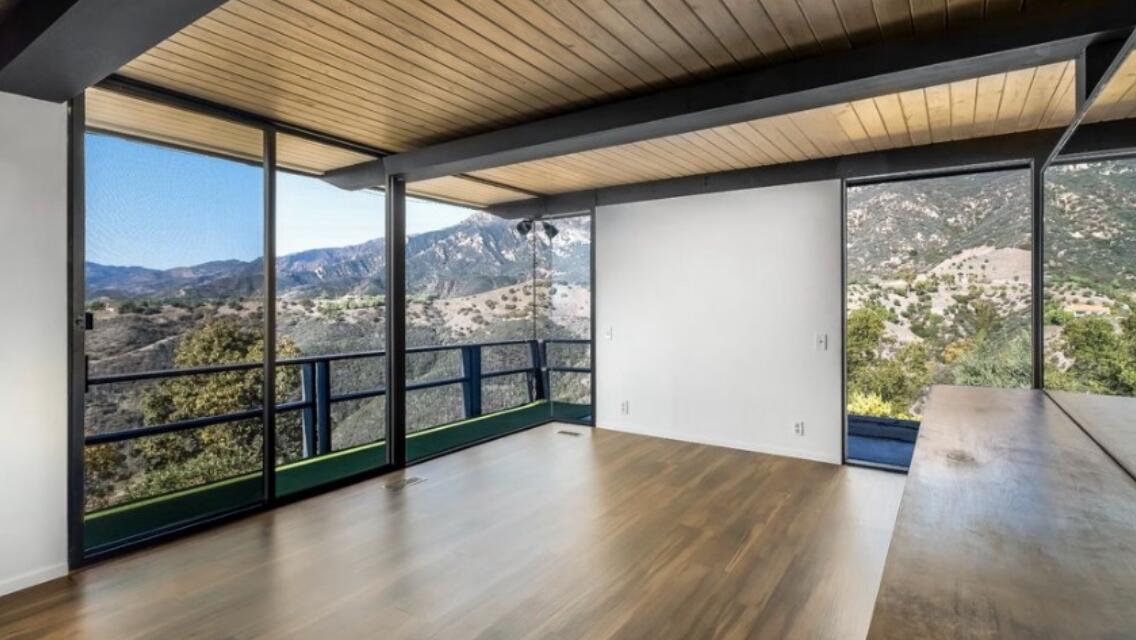 2911 Holly Road Santa Barbara, CA 93105 - Photo 7 of 20 an empty room with wooden floor and windows