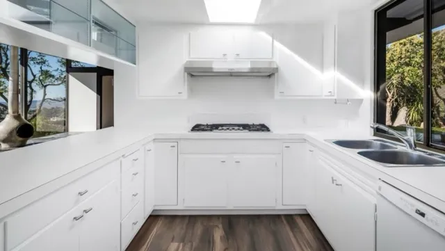 a kitchen with granite countertop a sink and a stove