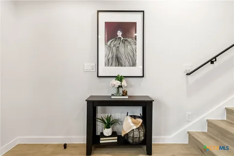 a view of a hallway with a small kitchen