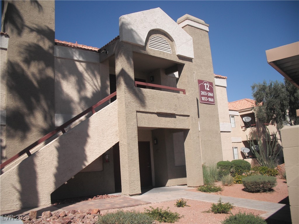 8600 West Charleston Boulevard, Unit 1060 Las Vegas, NV 89117 - Photo 2 of 14 Entrance to property with stucco siding and a tiled roof