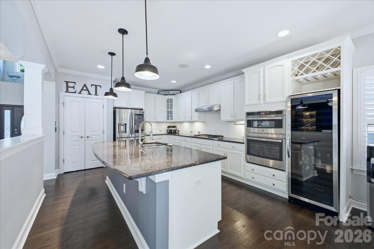 1825 Laveta Road Charlotte, NC 28269 - Photo 15 of 48 a kitchen with stainless steel appliances granite countertop a sink a stove and a refrigerator