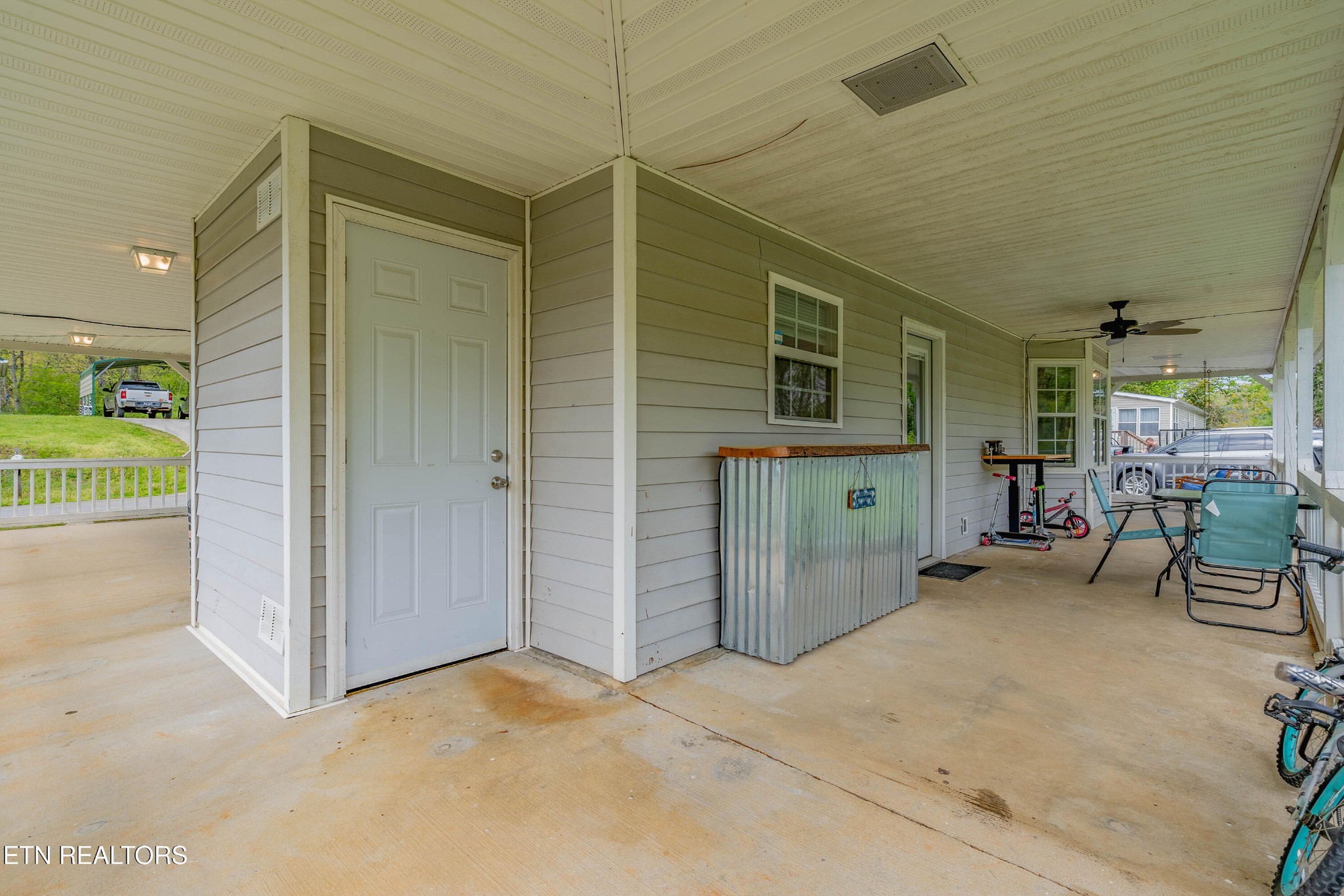 632 Butler Mill Road Oliver Springs, TN 37840 - Photo 26 of 34 a view of a patio with table and chairs and door