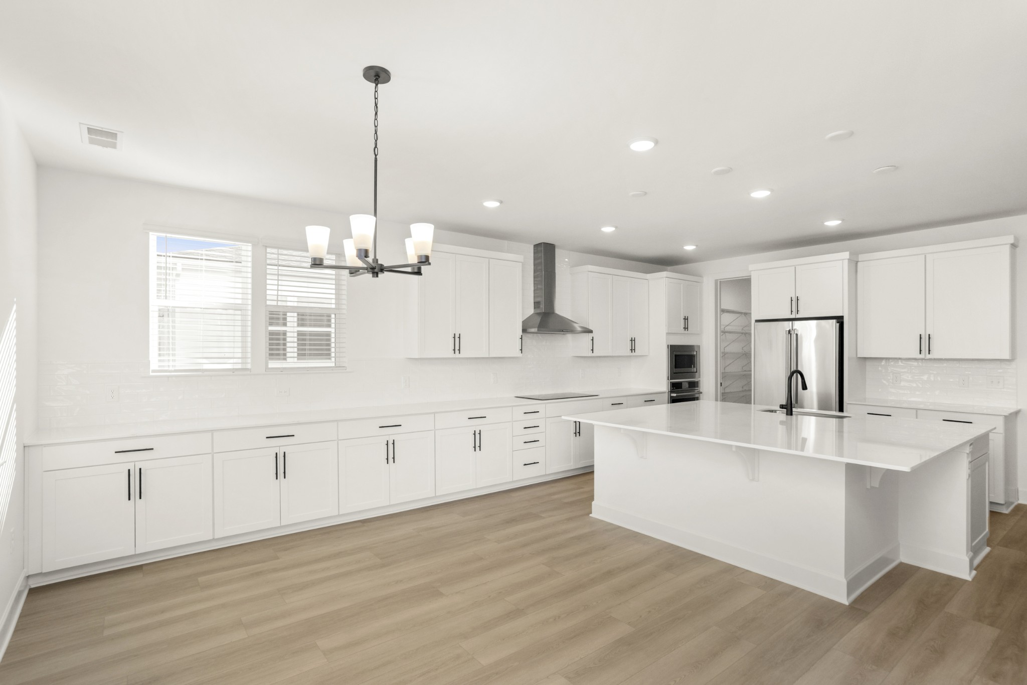 205 Acmon Blue Road Mount Juliet, TN 37122 - Photo 15 of 64 a large white kitchen with center island and stainless steel appliances