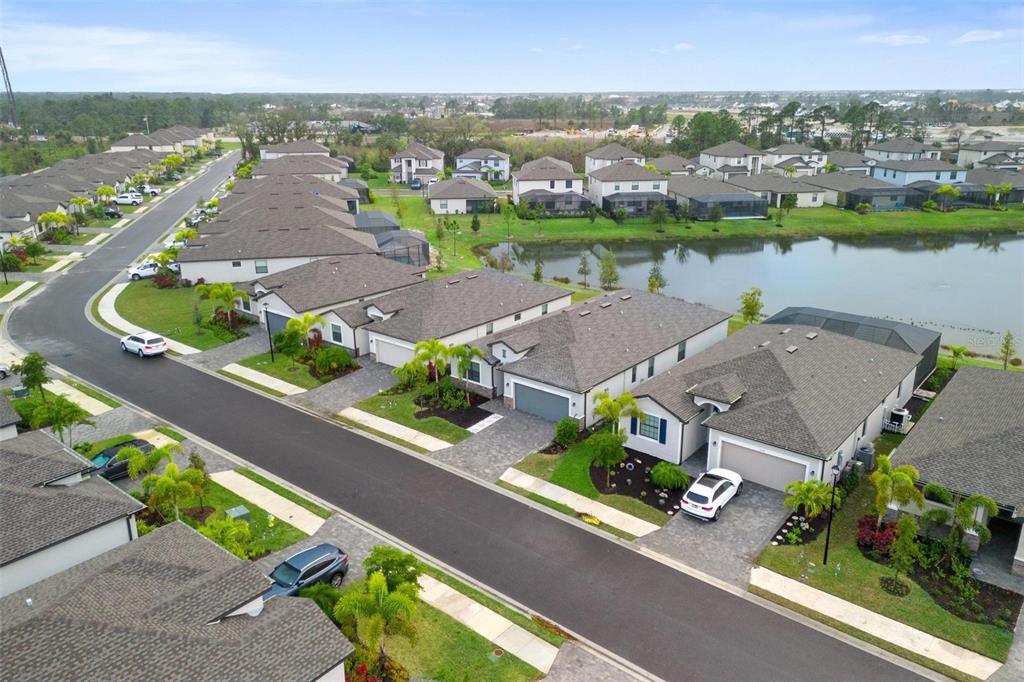 19729 Fishhawk Trail Venice, FL 34293 - Photo 42 of 45 an aerial view of a house with a garden and lake view