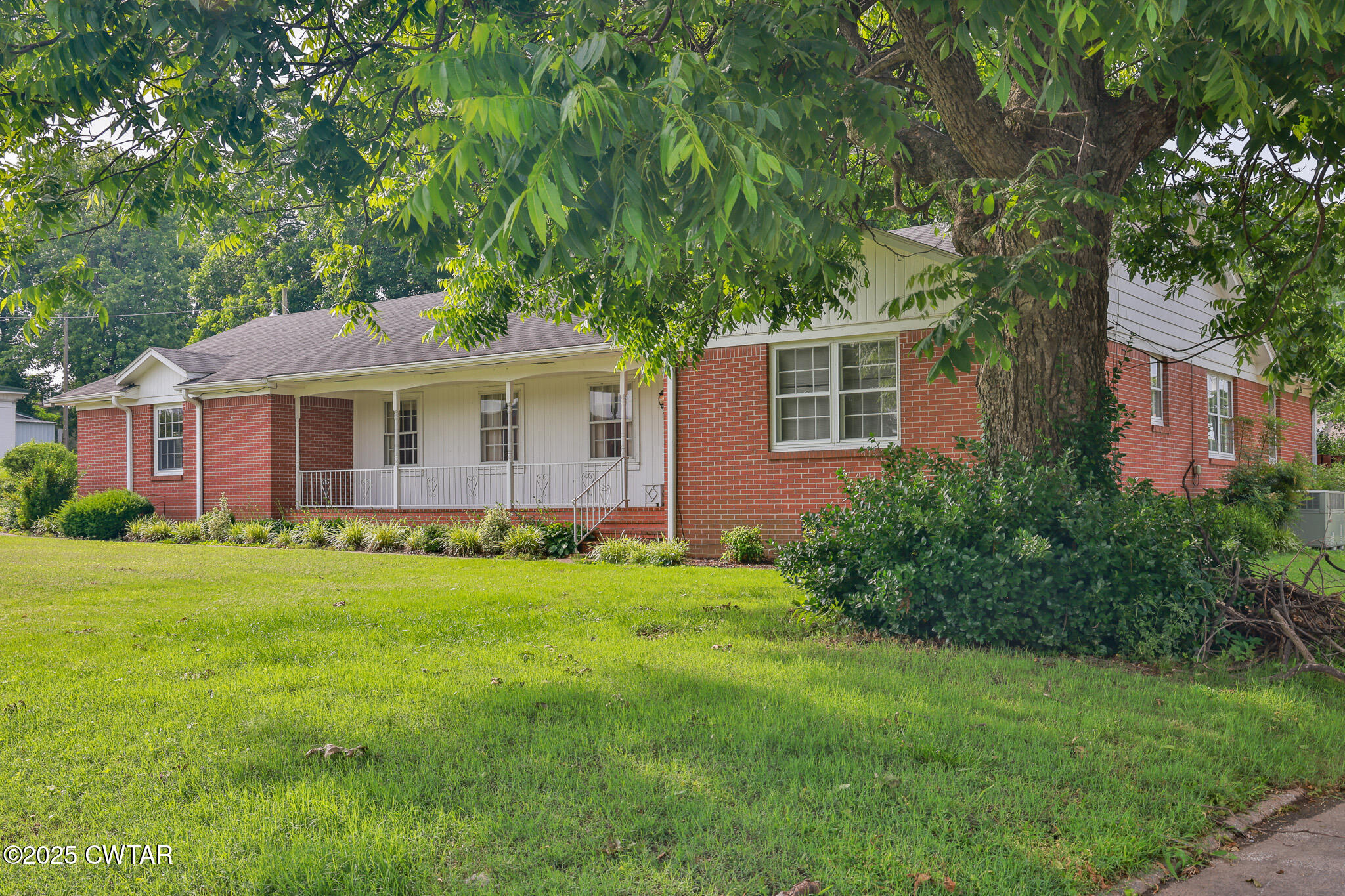 103 West Main Street Greenfield, TN 38230 - Photo 5 of 25 a front view of a house with a garden