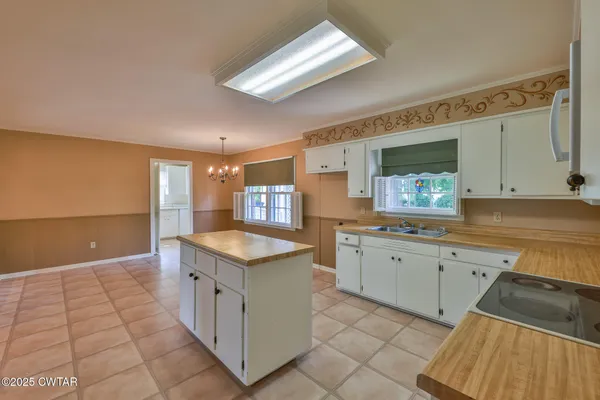 a kitchen with granite countertop a sink and a stove