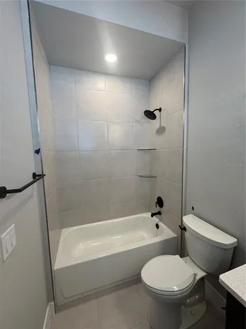 a bathroom with a bathtub and toilet