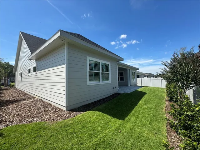 a view of a house with yard and a garden