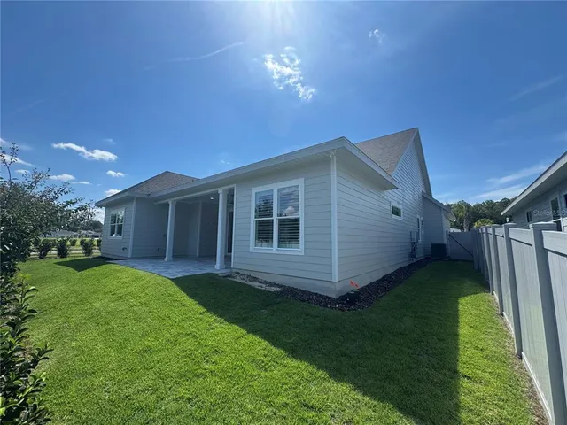 a view of a house with a yard and pathway