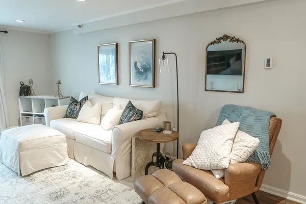 a living room with furniture and a painting