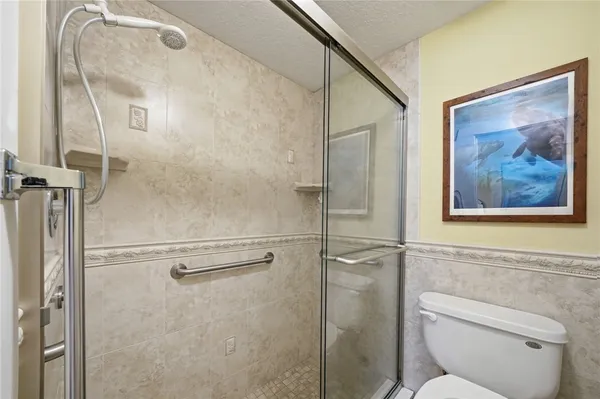 a bathroom with a toilet and a shower