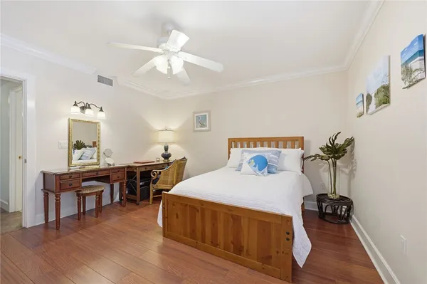 a bedroom with furniture and a wooden floor