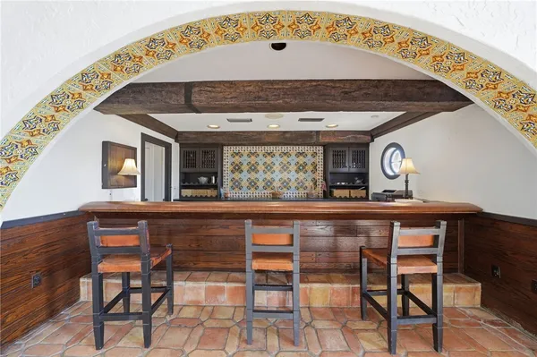 a kitchen with a stove a table and chairs in it