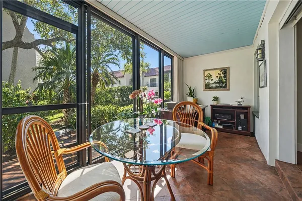 a view of a balcony dining table and chairs with wooden floor