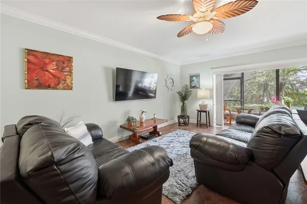 a living room with furniture ceiling fan and a rug