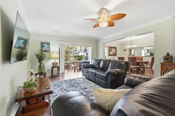 a living room with furniture kitchen view and a window