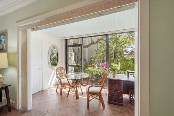 a dining room with furniture and a window