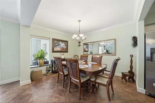 a view of a dining room with furniture and chandelier