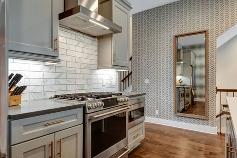 a kitchen with stainless steel appliances granite countertop a stove and a cabinets
