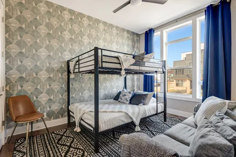 a bedroom with furniture and a window