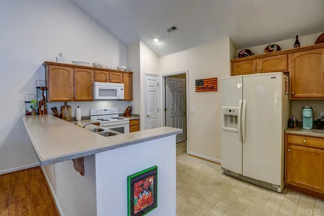 a kitchen with stainless steel appliances a refrigerator and a stove