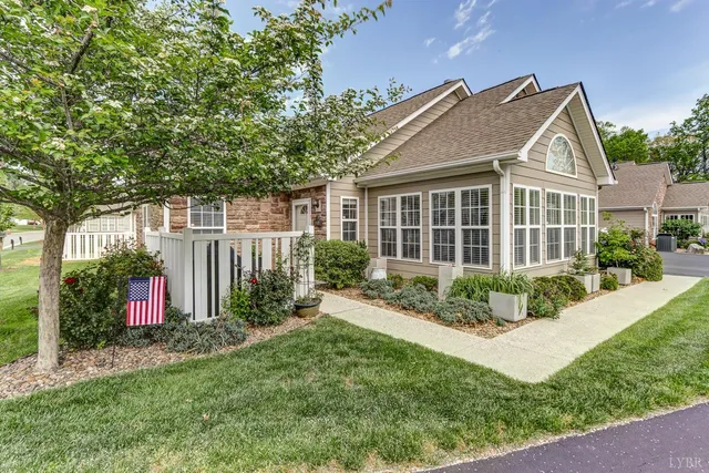 a view of a house with brick walls and a yard with plants