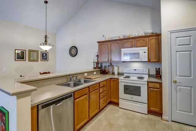 a kitchen with stainless steel appliances granite countertop a sink and a stove