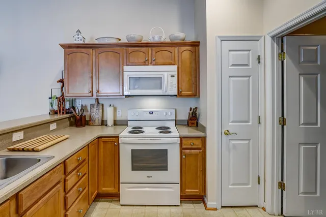 a kitchen with stainless steel appliances granite countertop a stove microwave and cabinets