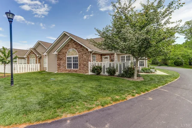 a front view of a house with a garden and yard