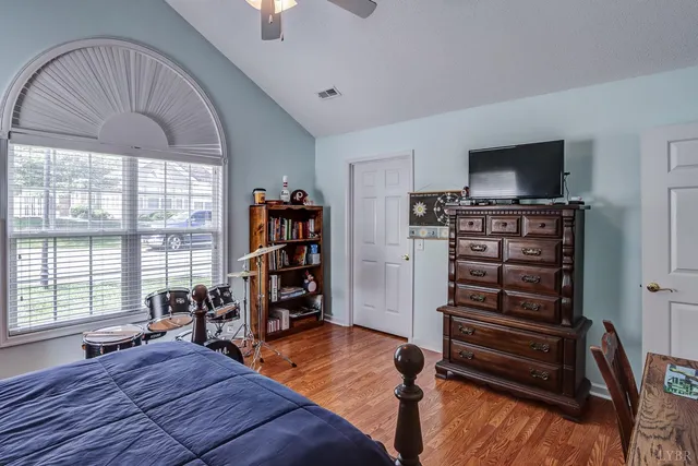 a bedroom with furniture and a flat screen tv