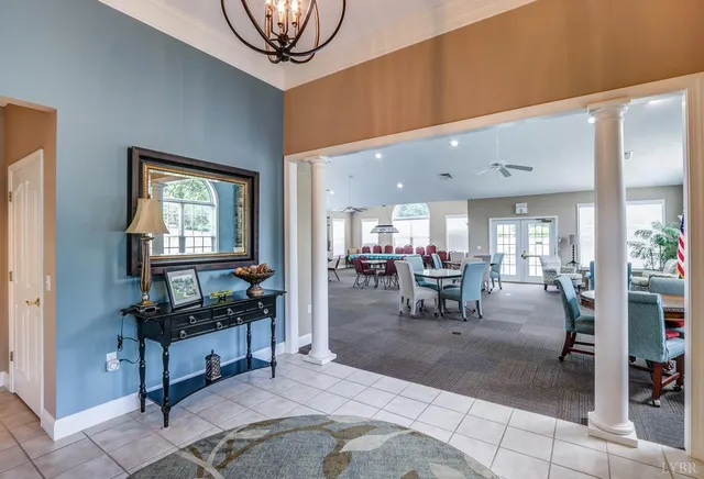 a living room with lots of furniture and a chandelier