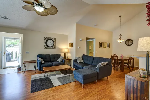 a living room with furniture wooden floor and a window