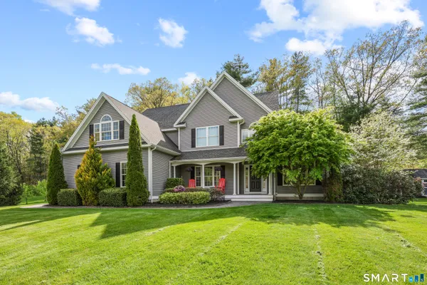 a front view of a house with a garden