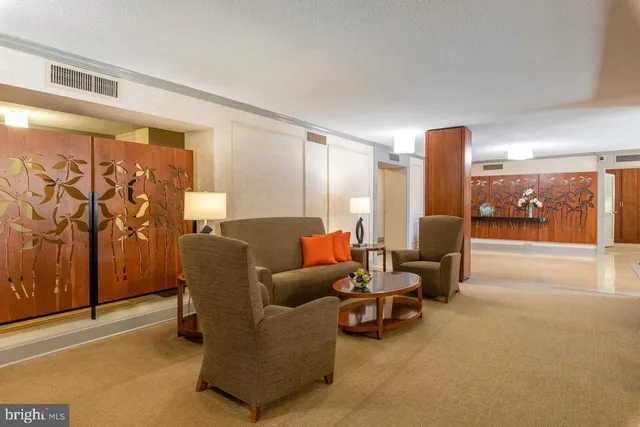 a living room with furniture and a lamp