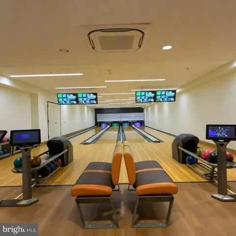 a room with furniture and view of kitchen