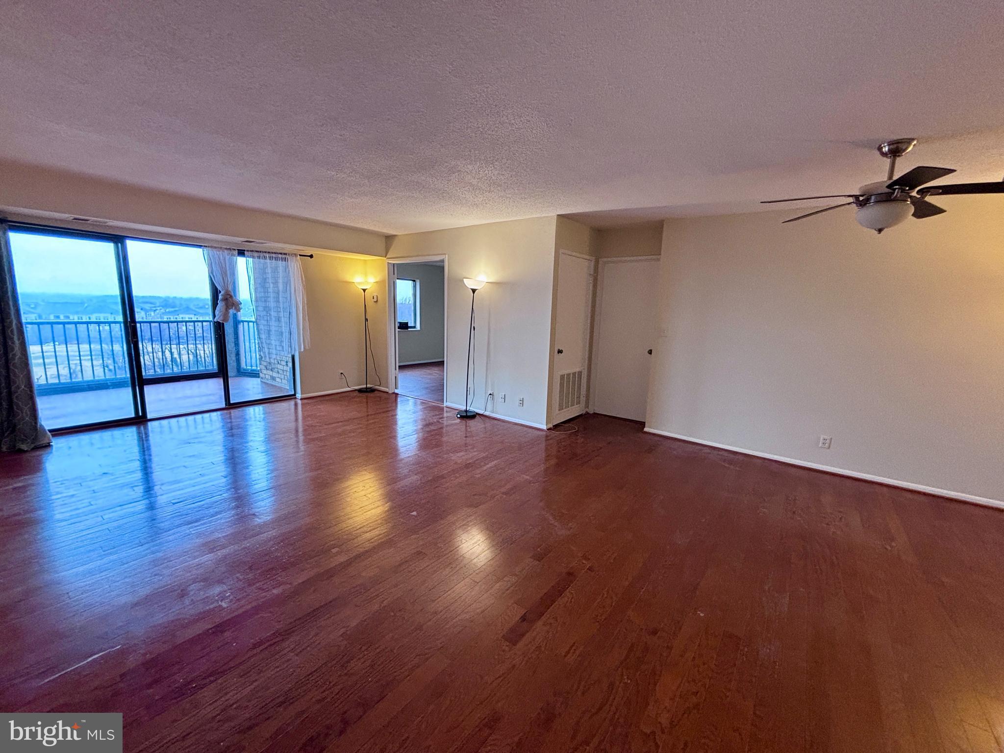 5901 Mt Eagle Drive, Unit 1009 Alexandria, VA 22303 - Photo 2 of 17 wooden floor in an empty room with a window