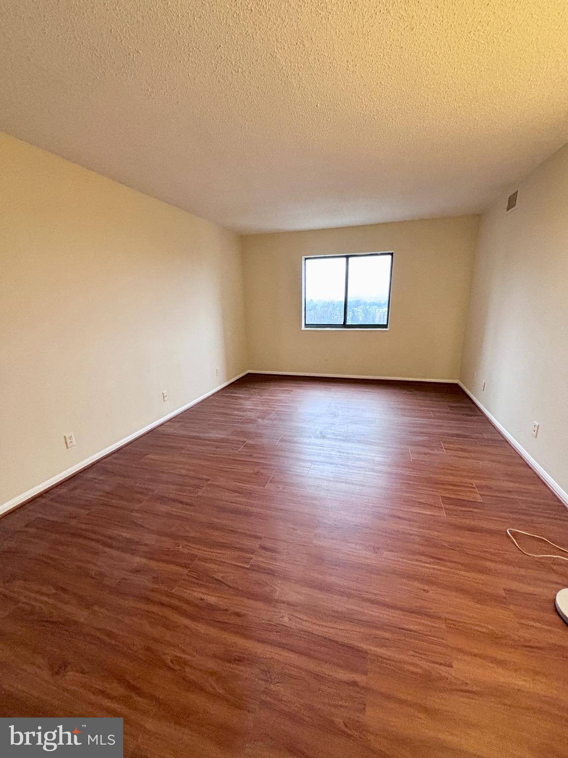 5901 Mt Eagle Drive, Unit 1009 Alexandria, VA 22303 - Photo 5 of 17 an empty room with wooden floor and windows